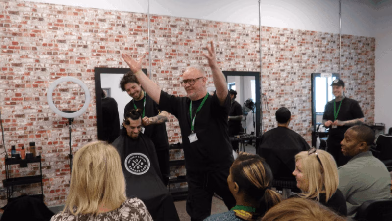 Staff at HMP Fosse Way in a barbering workshop.