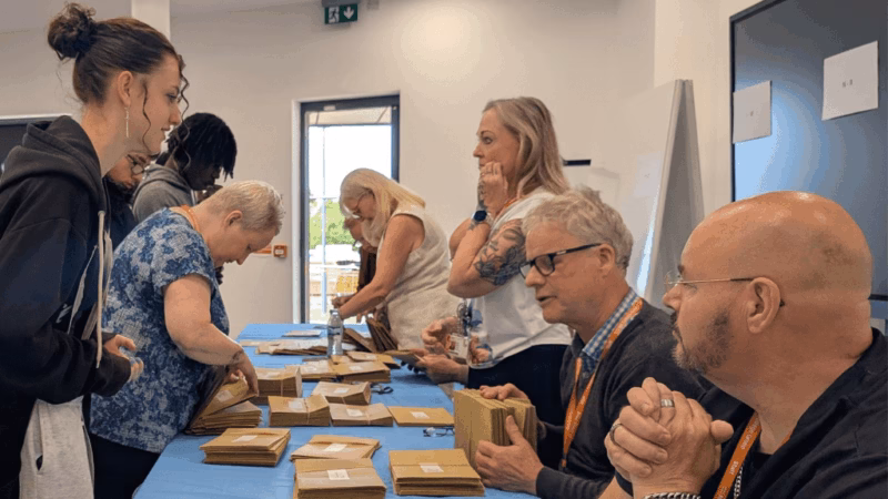 MK College learners collecting their GCSE resit results from MK College staff