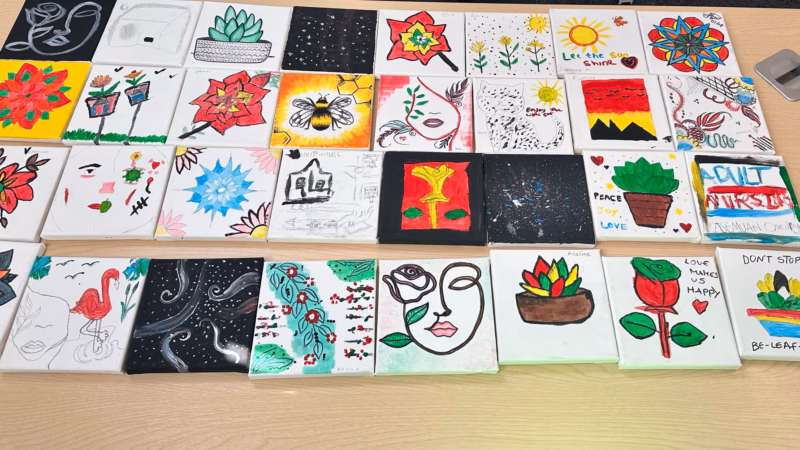 Crafts made by Access to HE students in collaboration with home care provider Home Instead. The crafts are a set of tiles with a range of designs including flowers, cats, bees and landscapes.