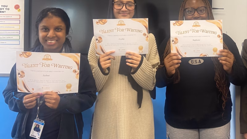 Three students from Milton Keynes College holding up their Young Writers Awards.