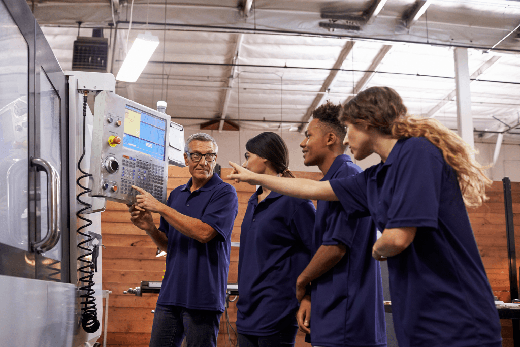 Students and teacher stood around a machine