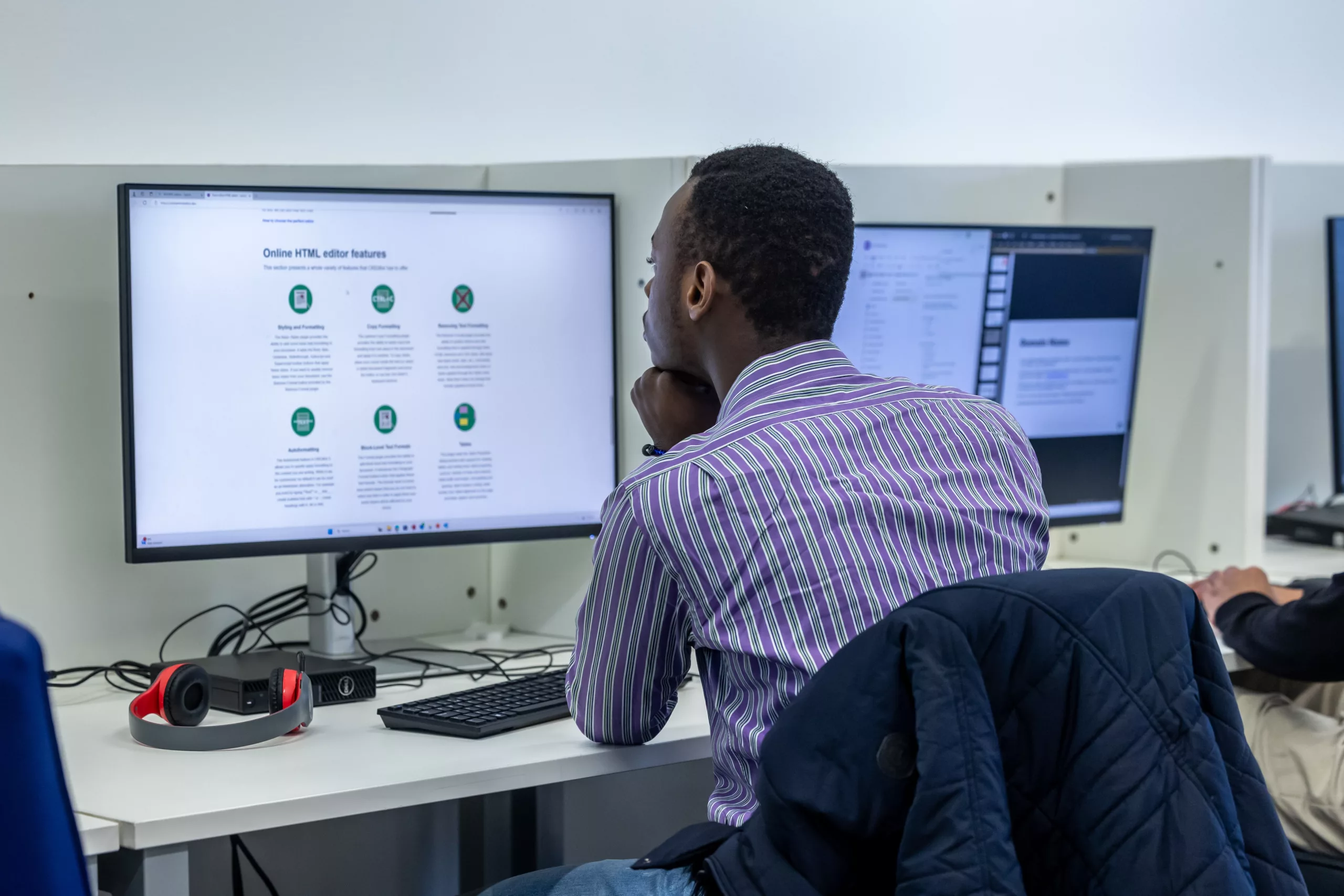 A student looking at data on a large computer monitor.