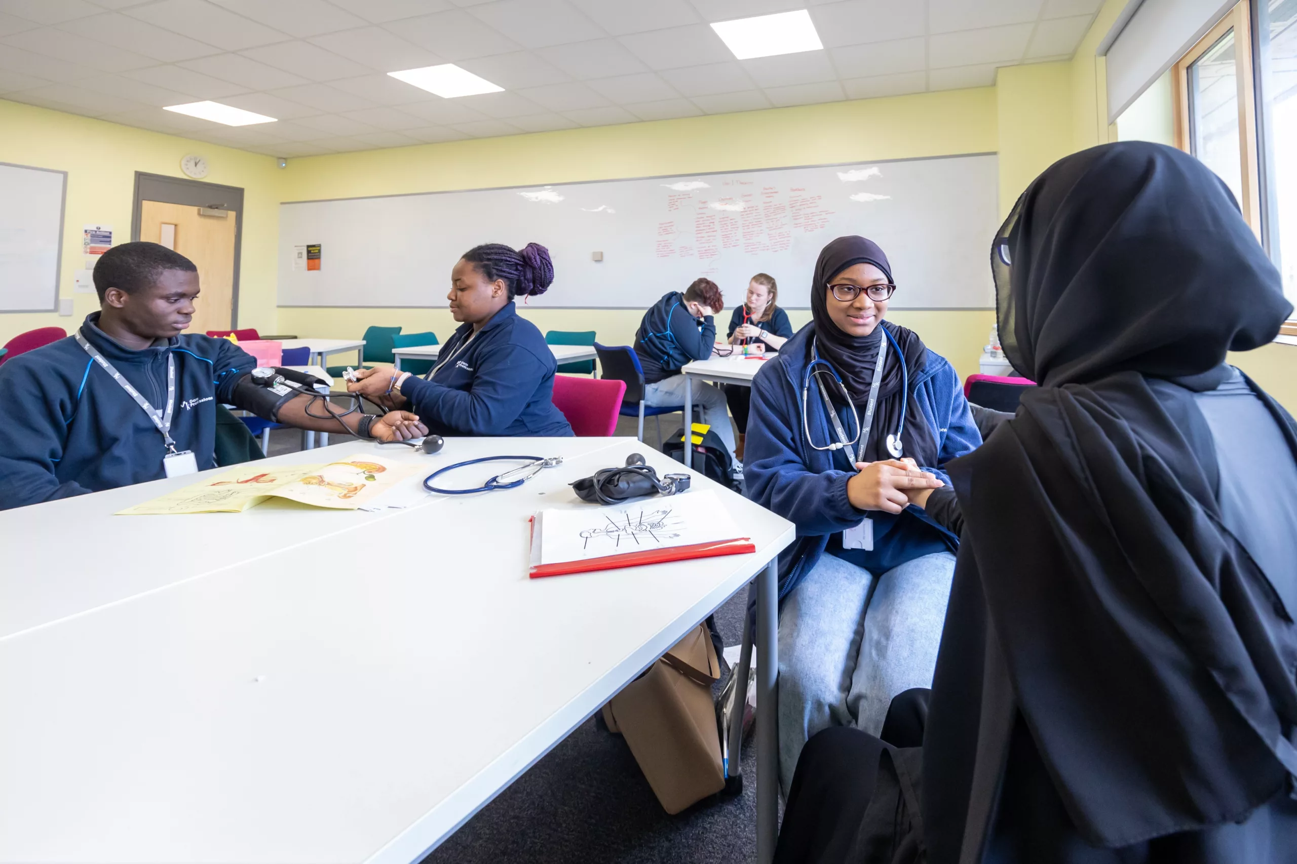 College students in a health lab working on an experiment