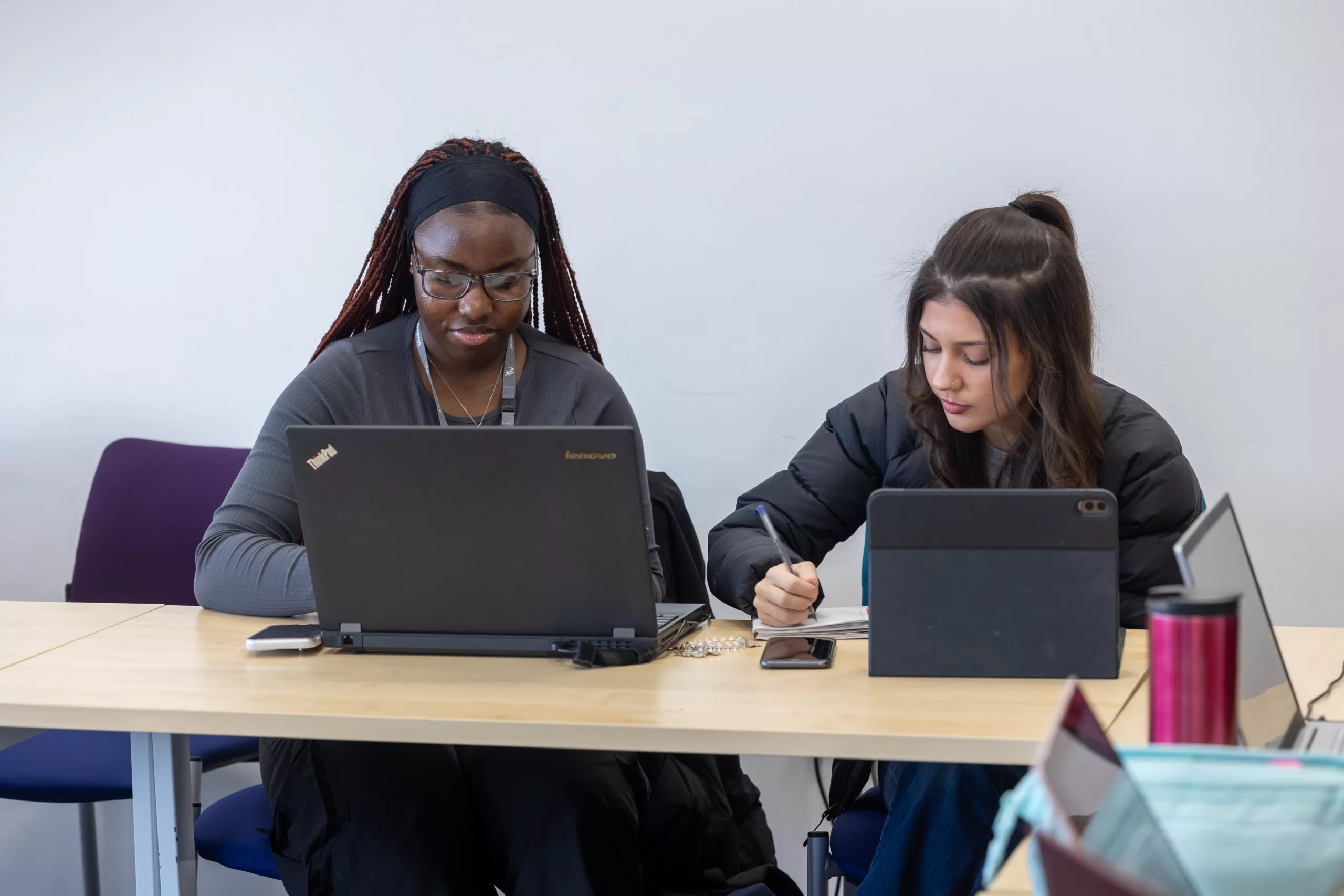 Students using a laptop in a learning environment.