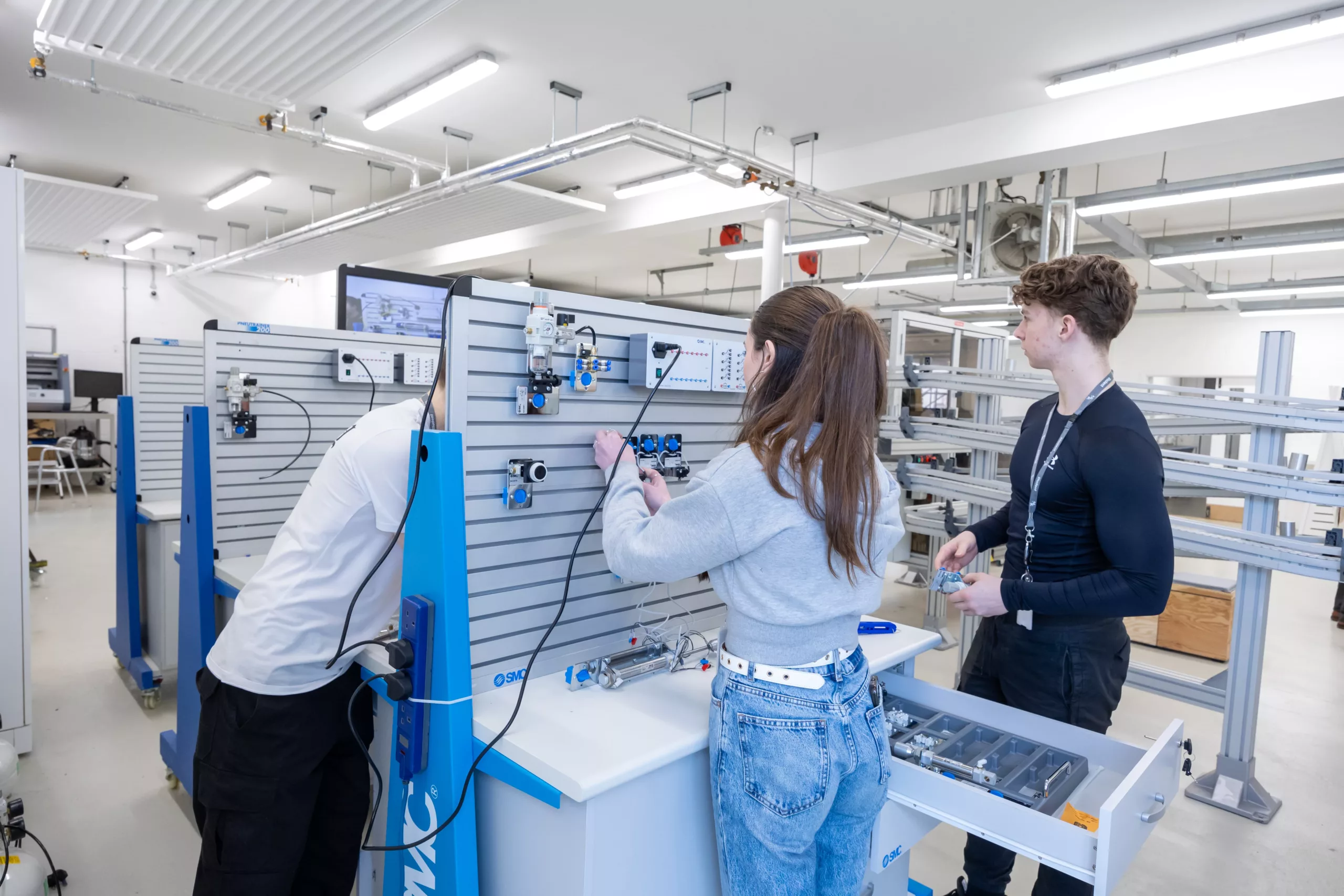 Engineering student using machinery in a workshop – A learner engaged in a hands-on engineering task.