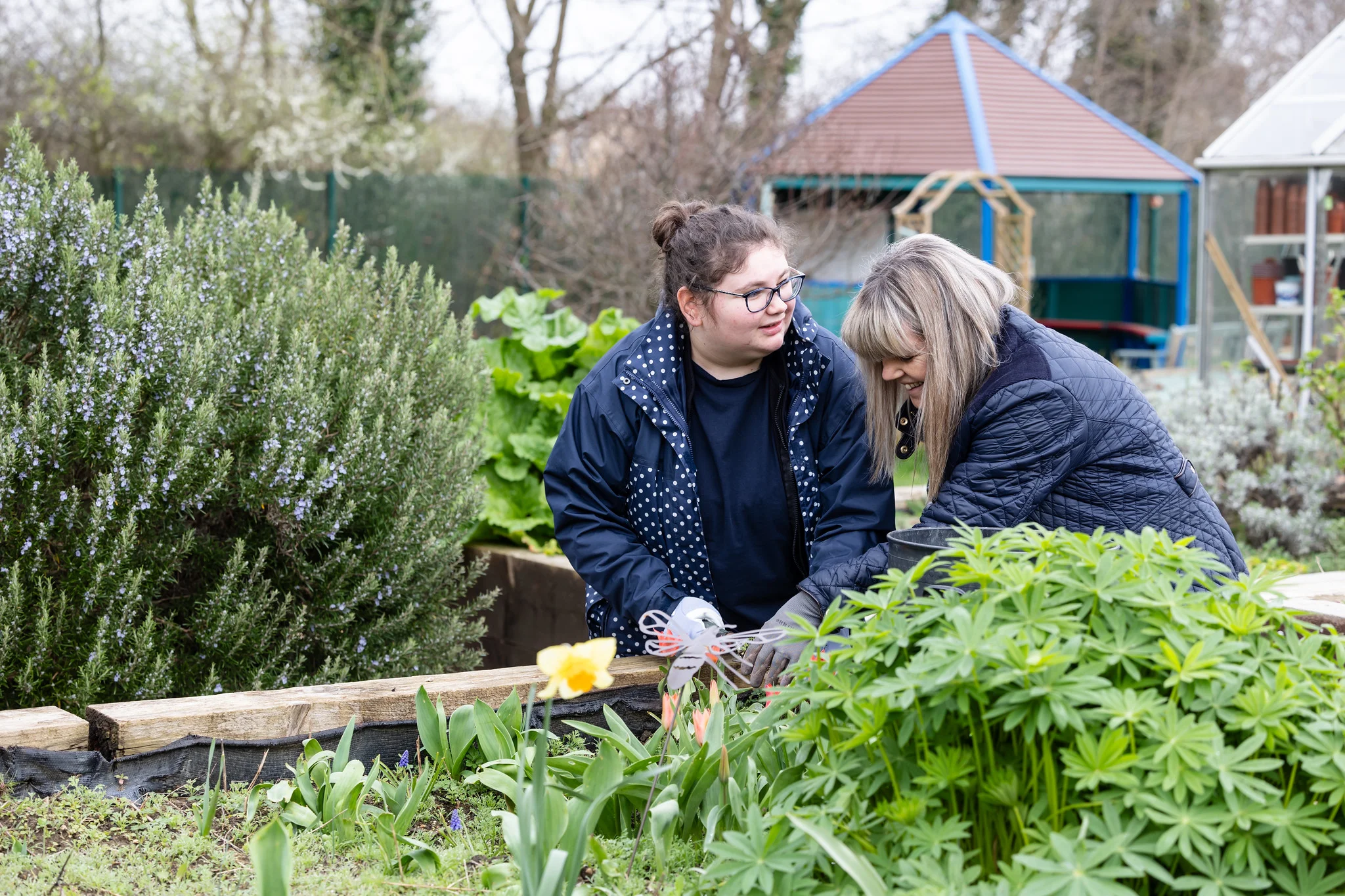 College students engaged in a practical gardening workshop.