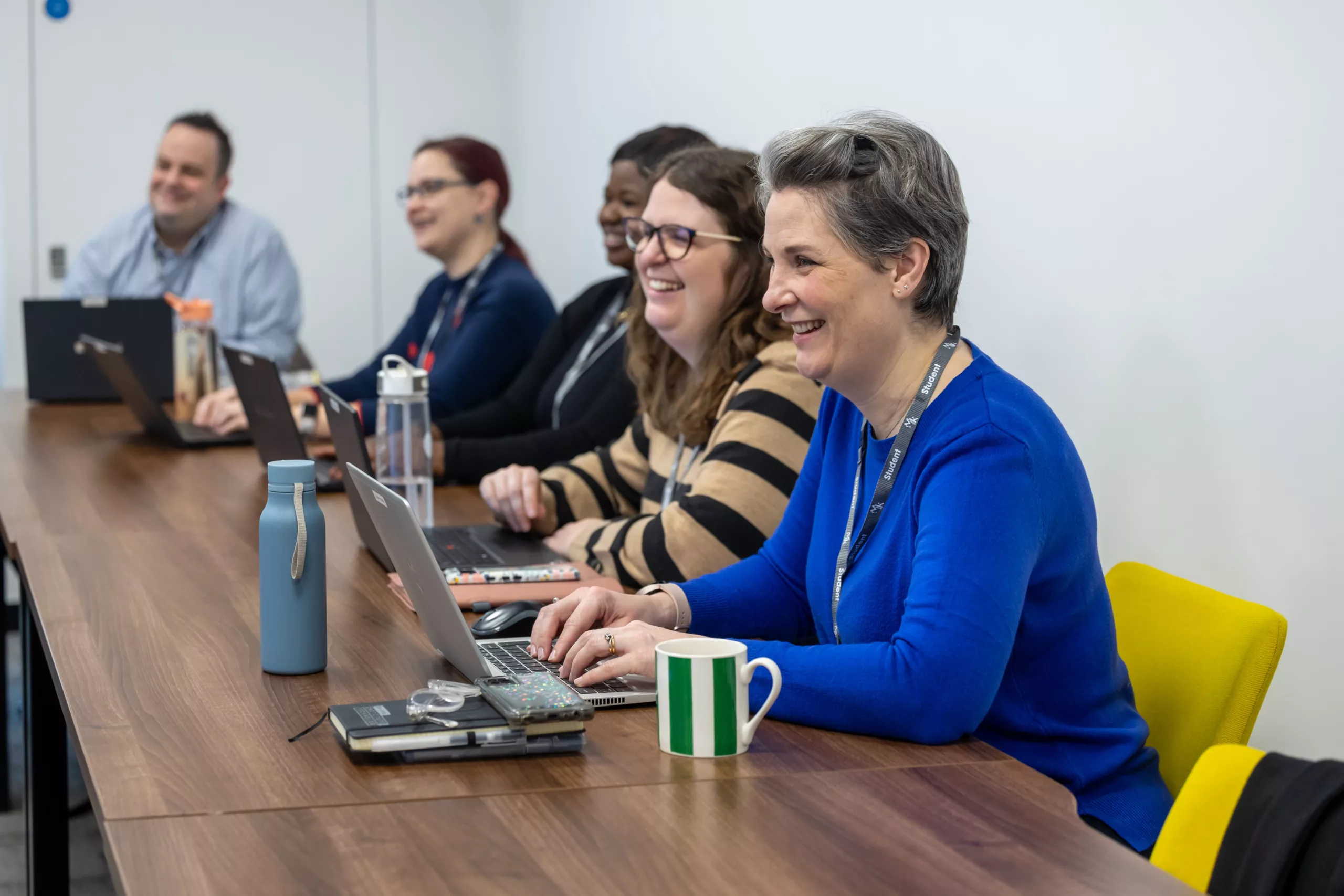 Students using a laptop in a learning environment.