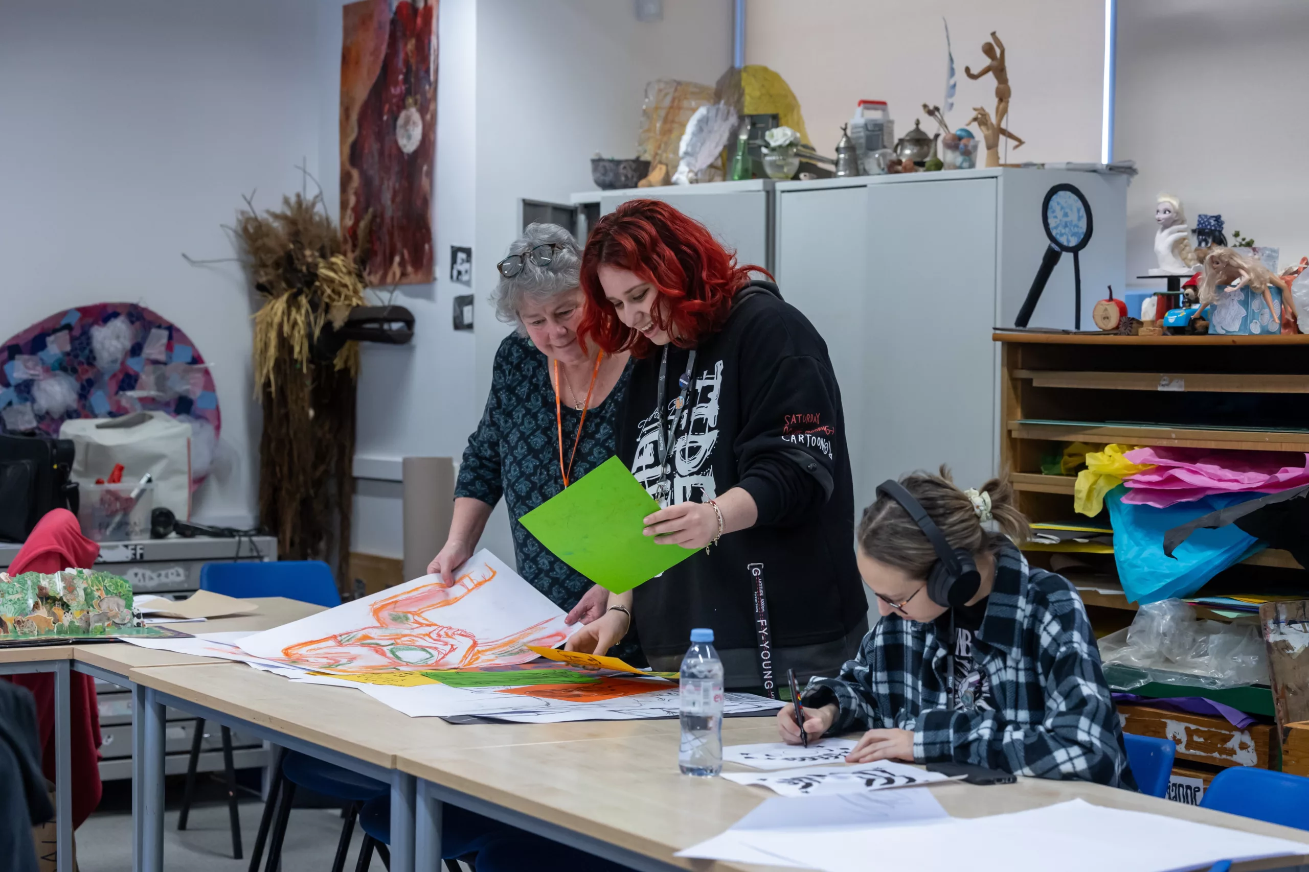Arts students sharing paintings with their tutor