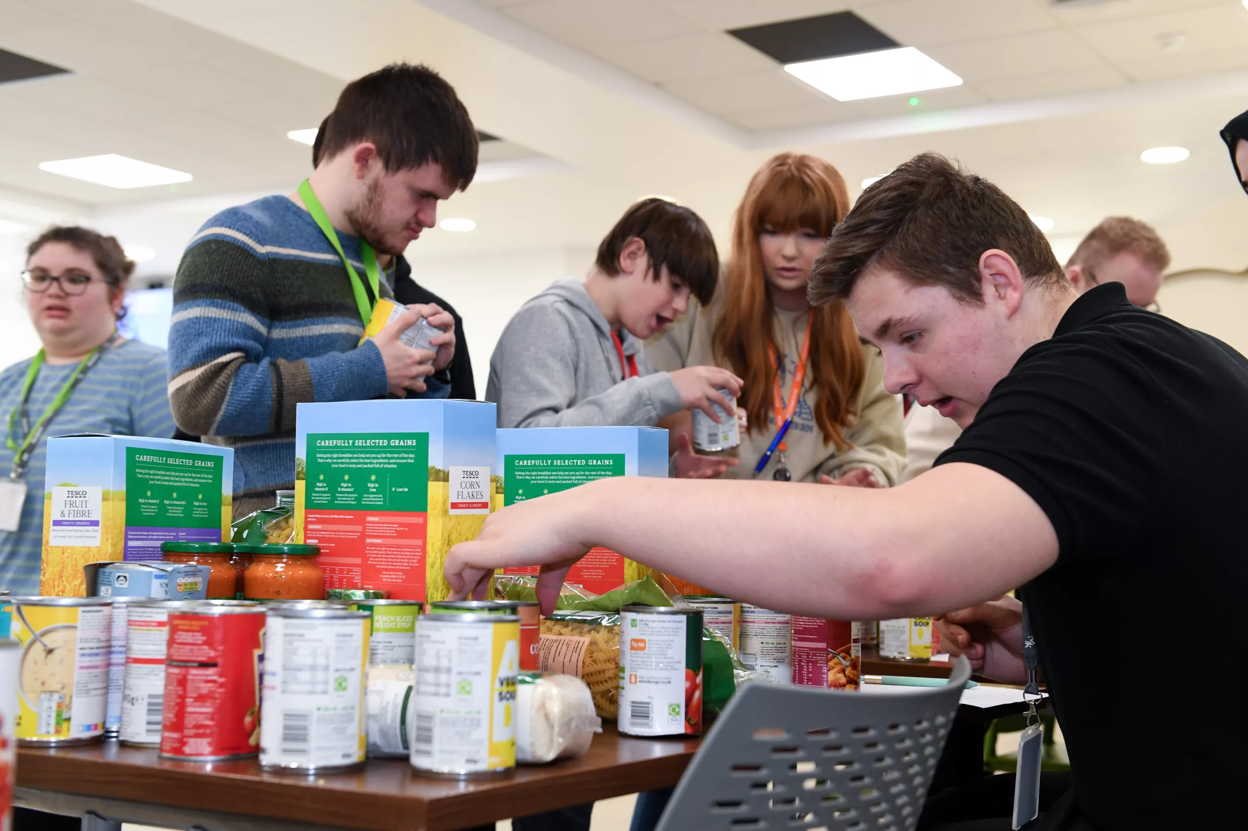 Students volunteering at a food bank, sorting donations.